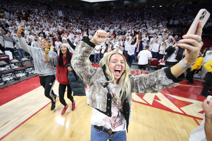 An Arkansas student rushes the court after the Razorbacks upset Auburn at Bud Walton Arena.